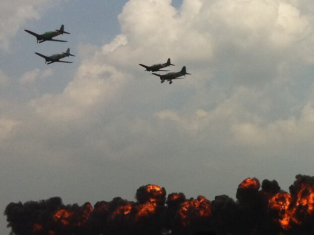 Aircraft painted like WWII Japanese zeros simulate a bombing raid during the Tora! Tora! Tora! performance at the Charleston Air Expo 2011 April 9. The Tora! Tora! Tora! peformance is a historic re-enactment of the bombing of Pearl Harbor. Nearly 80,000 people attended the event to experience more than a dozen aerial performances as well as numerous static aircraft displays. (U.S. Air Force photo/ 2nd Lt. Susan Carlson) 
