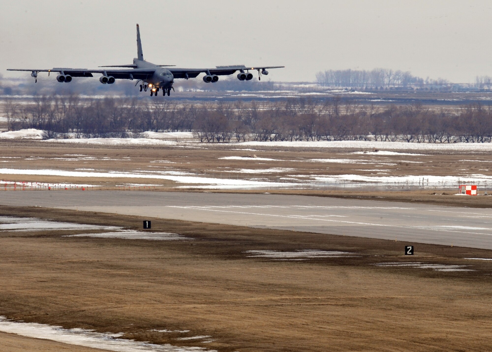MINOT AIR FORCE BASE, N.D. -- A B-52H Stratofortress lands after a five month deployment to Andersen AFB, Guam, here April 7. Team Minot’s 69th Bomb Squadron and 5th Bomb Wing personnel deployed to Andersen AFB last November in support of U.S. Pacific Command’s Continuous Bomber Presence. This was the 69th BS' first deployment since it’s reactivation in September 2009 and the first major combat deployment of aircraft and personnel since World War II. (U.S. Air Force photo/Staff Sgt. Keith Ballard)

