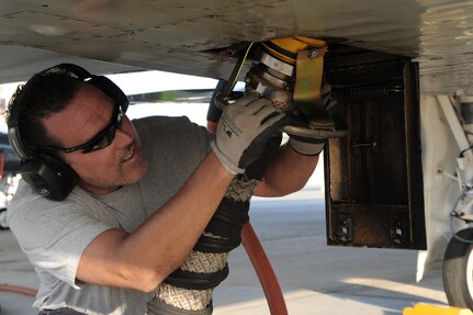 Todd Aguinaga, 12th Flying Training Wing maintenance directorate, connects a compressed air hose for a T-38 Talon engine air start at Randolph Air Force Base, Texas, April 11. Maintenance workers here prepare and launch a large variety of aircraft daily. (U.S. Air Force photo/Airman Alexis Siekert)