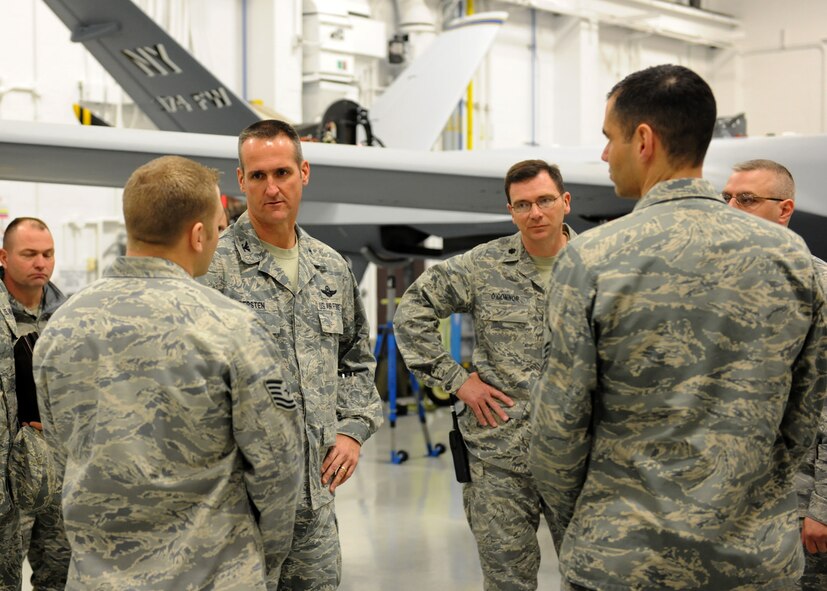 The Commander of the 432nd Air Expeditionary Wing, U.S. Air Force Col. Pete Gersten (third from left), visits with instructors at the MQ-9 Reaper maintenance Field Training Detachment at Hancock Field in Syracuse, NY on 5 April 2011. Gersten was touring the detachment while visiting the base to view the current MQ-9 operations at Hancock Field. (US Air Force photo by Tech. Sgt. Jeremy M. Call)