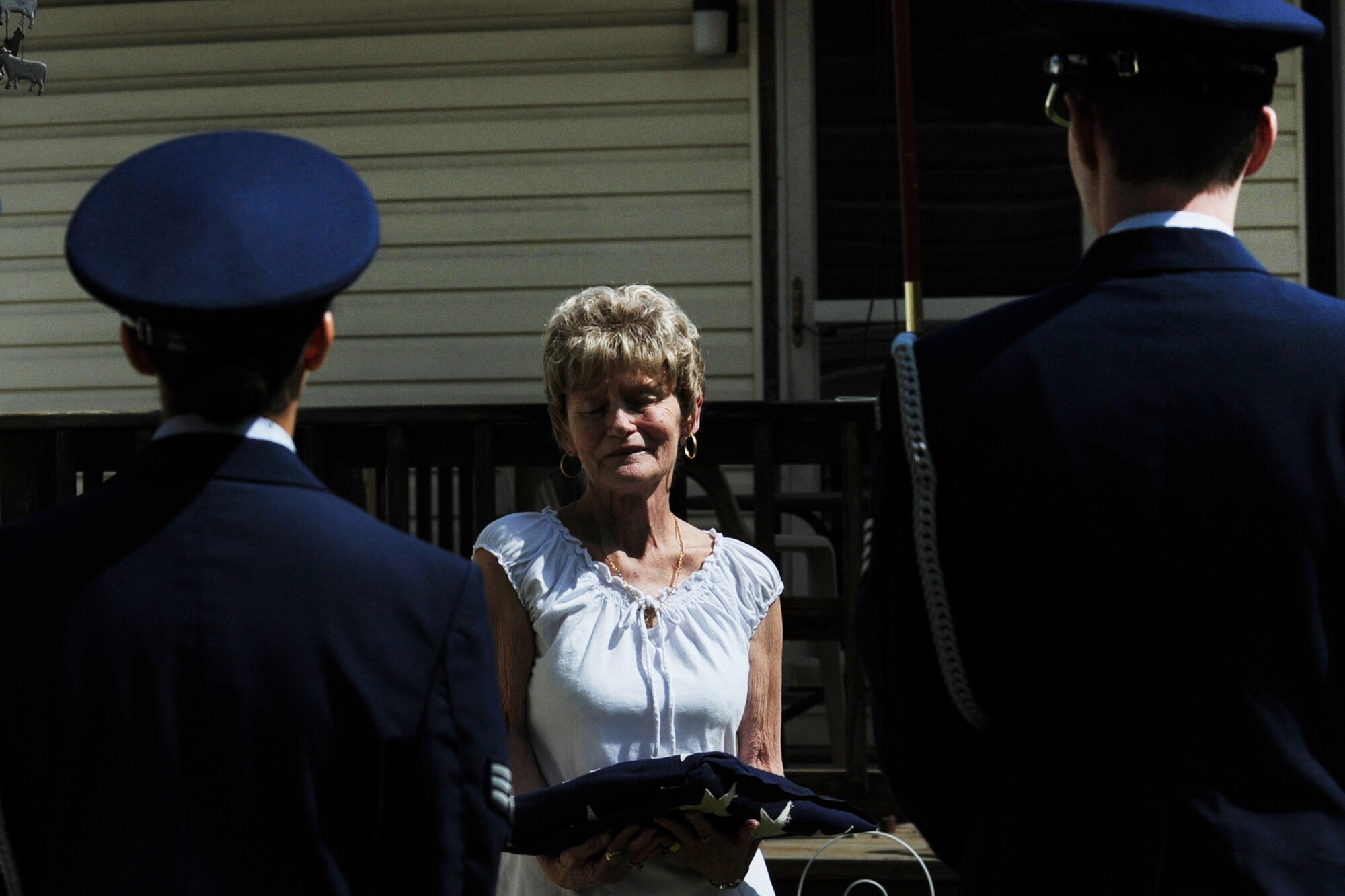 The Langley Air Force Base Honor Guard presents Mrs. Judith Minor-Spangler with her father?s 53 year old historic flag after folding it on her behalf, April 11, 2011. Mrs. Minor-Spangler requested the honor guard preserve the historic flag, which only has 48 stars, to honor her father, George Minor, who served as an Army medic and passed away in 1953. (U.S. Air Force photo by Senior Airman Brian Ybarbo/Released) 

