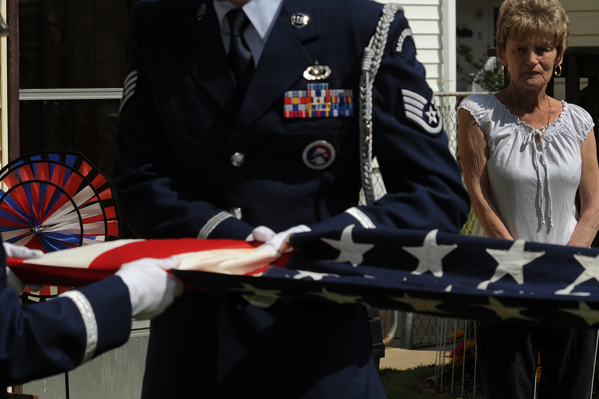Mrs. Judith Minor-Spangler watches as the Langley Air Force Base Honor Guard folds her 53 year old flag, April 11, 2011. The historic flag, with only 48 stars, was passed down to Mrs. Minor-Spangler by her father, George Minor, who was an Army medic. (U.S. Air Force photo by Senior Airman Brian Ybarbo/Released)

