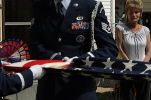 Mrs. Judith Minor-Spangler watches as the Langley Air Force Base Honor Guard folds her 53 year old flag, April 11, 2011. The historic flag, with only 48 stars, was passed down to Mrs. Minor-Spangler by her father, George Minor, who was an Army medic. (U.S. Air Force photo by Senior Airman Brian Ybarbo/Released)

