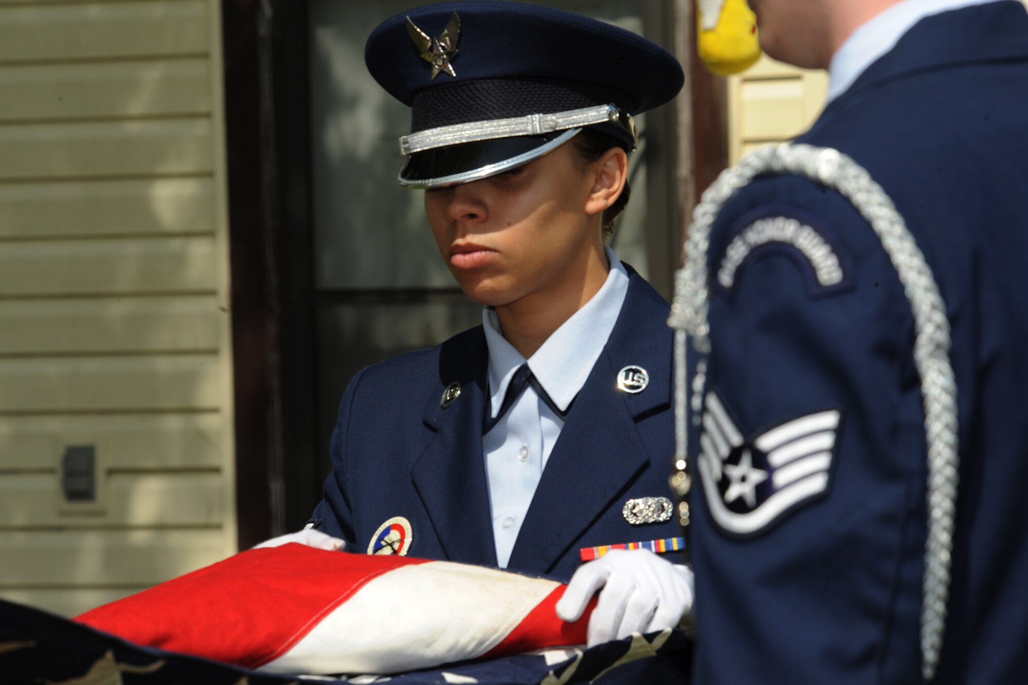 Senior Airman Keturah Payton, and Staff Sgt. Logan Tuttle, Langley Air Force Base Honor Guard members, fold a historic flag with only 48 stars belonging to Mrs. Judith Minor-Spangler. Mrs. Minor-Spangler preserved the flag for over 50 years in her father?s, George Minor, honor. (U.S. Air Force photo by Senior Airman Brian Ybarbo/Released)
