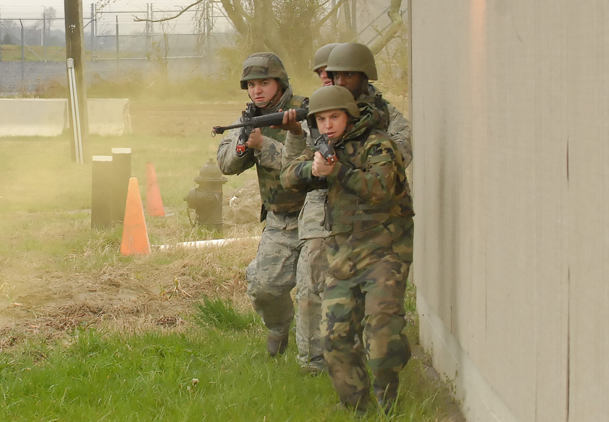 Four members of Expeditionary Combat Skills Training class advance their tactical position while scanning the area for enemy fire during Mobile Operations and Urban Terrain training at Base X April 8, 2011, at Dover Air Force Base, Del. This was part of Expeditionary Combat Skills Training, which is a prerequisite for deployment.   (U.S. Air Force photo by Airman 1st Class Jacob Morgan)