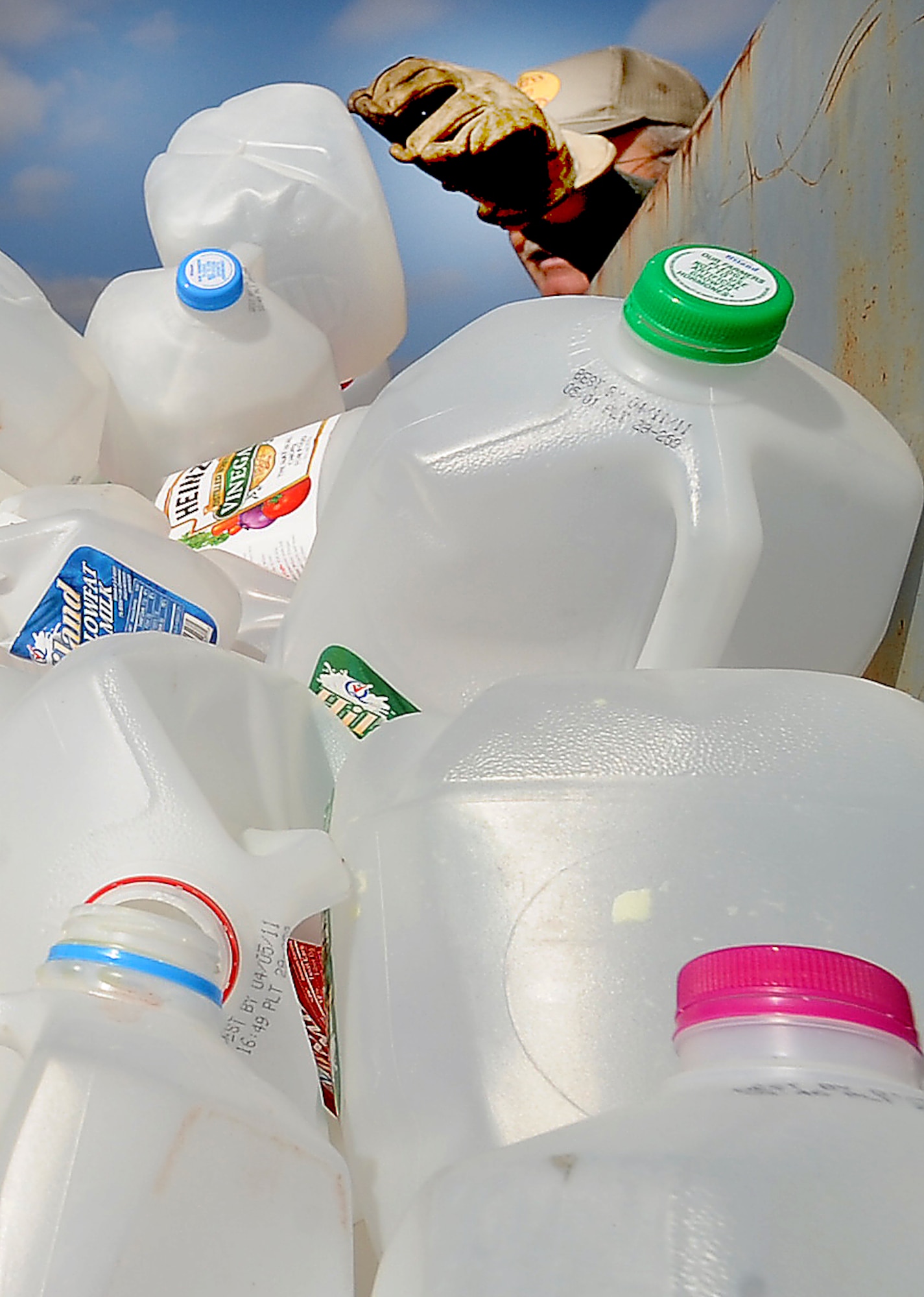 WHITEMAN AIR FORCE BASE, Mo. -- Several plastic jugs are loaded into a recycle bin for transport as recyclables are organized April 11, 2011. The recycling center accepts materials from paper and aluminum to plastic. For each category of recyclable material there are different sections that should be separated, such as colored and clear plastics.  (U.S. Air Force photo by Senior Airman Kenny Holston)(Released)  


