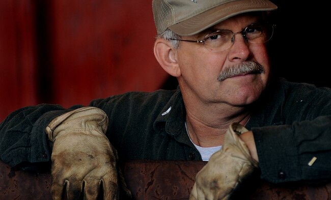 WHITEMAN AIR FORCE BASE, Mo. -- Mr. Mark Davis, head supervisor at Whiteman’s Recycling Center leans against a recycling dumpster while waiting for the next load of recyclables to arrive April 11, 2011. Airmen and their families using the recycling center can help save thousands of dollars by keeping trash companies from having to pick up the waste while also helping the Air Force stay eco-friendly. (U.S. Air Force photo by Senior Airman Kenny Holston)(Released)
