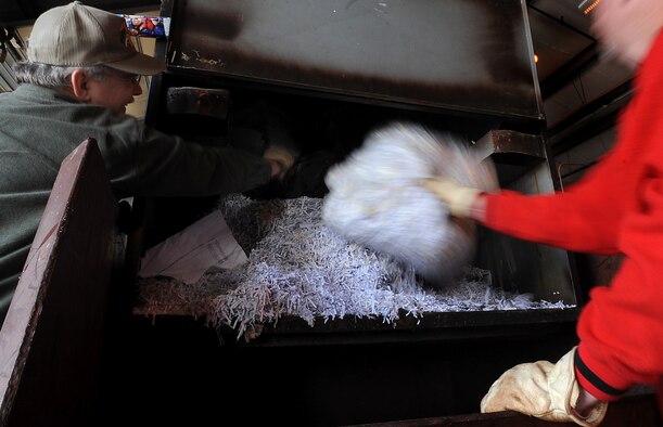WHITEMAN AIR FORCE BASE, Mo. -- Members of the Whiteman Recycling Center empty shredded paper from a dumpster April 11, 2011. The recycling center accepts materials from paper and aluminum to plastic. For each category of recyclable material there are different sections that should be separated, such as colored and clear plastics. (U.S. Air Force photo by Senior Airman Kenny Holston)(Released)  



