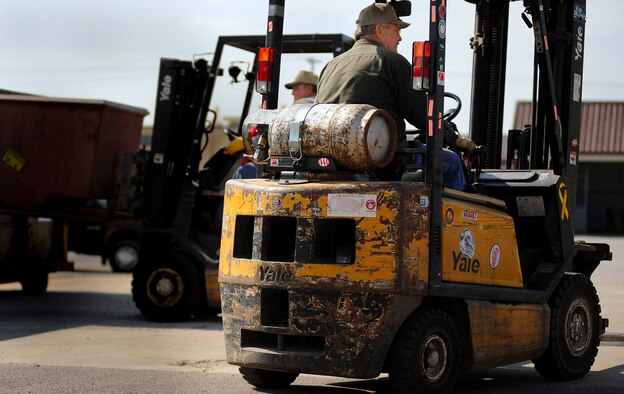 WHITEMAN AIR FORCE BASE, Mo. -- Members of the Whiteman Recycling Center transport recycling containers to organize recycled materials April 11, 2011. Airmen and their families using the recycling center they help save thousands of dollars by keeping trash companies from having to pick up the waste while also helping the Air Force stay eco-friendly. (U.S. Air Force photo by Senior Airman Kenny Holston)(Released)


