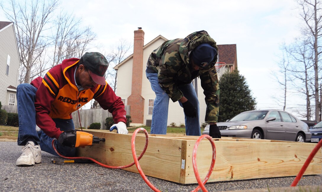 Volunteers from Joint Base Andrews frame a section of a wheelchair ramp being constructed by volunteers at the Callahan residence in Upper Marlboro, Md., April 2.  In conjunction with Christmas in April * Prince George's County, volunteers helped make the Callahan residence wheelchair accessible.  Daniel Callahan, 19,  was paralyzed in an automobile accident Jan. 23 on the Capital Beltway.  The accident also claimed the life of his 21 year old brother, David.  The boys' mother works for the Judge Advocate General at the Washington Navy Yard on Joint Base Andrews. (U.S. Air Force Photo by Senior Airman Torey Griffith.)(Released)