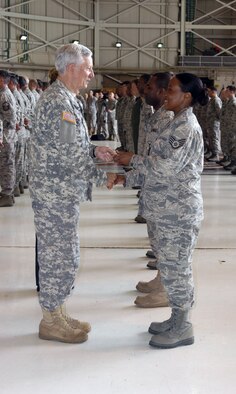 Mississippi Adjutant General Maj. Gen. William Freeman presents an ‘initial cadre’ patch to a staff sergeant assigned to the 286th Air Operations Group at Meridian Air National Guard Base, Miss.  The Adjutant General distributed one-of-a-kind patches to each member of the group during a stand-up ceremony held at the base April 8, 2011.  (U.S. Air Force photo by Lt. Col. Susan A. Romano)