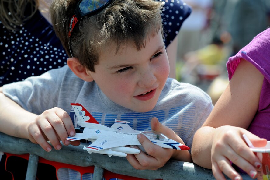 Anthony Alessandrini holds a model F-16 Thunderbird while the U.S. Air Force Thunderbirds performed for military members and their families April 8, 2011, at Joint Base Charleston, S.C. as part of Charleston Air Expo 2011. The Thunderbirds performed for nearly 80,000 people April 9 when the event was open to the public. Anthony is the four- year old son of Tech. Sgt. James Alessandrini, a Raven with the 628th Security Forces Squadron. (U.S. Air Force Photo/Staff Sgt. Nicole Mickle) 

