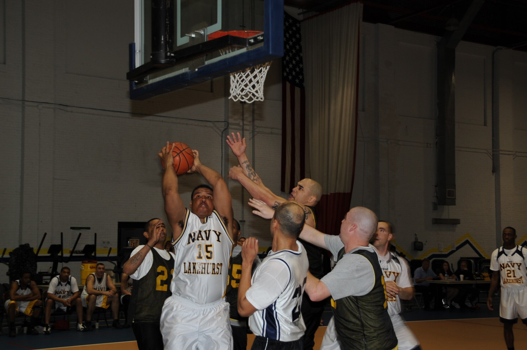Aviation Boatswains Mate Equipment 3rd Class Gregorio Decena, NSA launch and maintenance equipment maintainer, puts two points on the board for Navy Lakehurst during first intra service basketball game at the Lakehurst Fitness Center April 5. Navy went on to win the game 58 44 over Army. (U.S. Air Force photo by Airman 1st Class Dennis Sloan/Released)