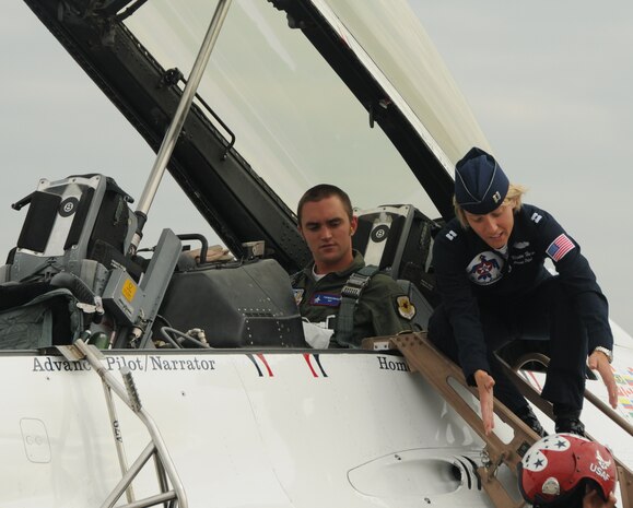 Capt. Kristin Hubbard prepares to fit a helmet on Ed Daes prior to his flight with the U.S. Air Force Thunderbirds on Joint Base Charleston, S.C., April 9. Mr. Daes received this incentive flight as a reward for his fund raising efforts for the Ronald McDonald House Charities, riding his bicycle from St. Augustine, Fla., to San Diego, Calif. Captain Hubbard is an advanced pilot and narrator with the U.S. Air Force Thunderbirds. (U.S. Air Force photo/Airman 1st Class Ian Hoachlander)