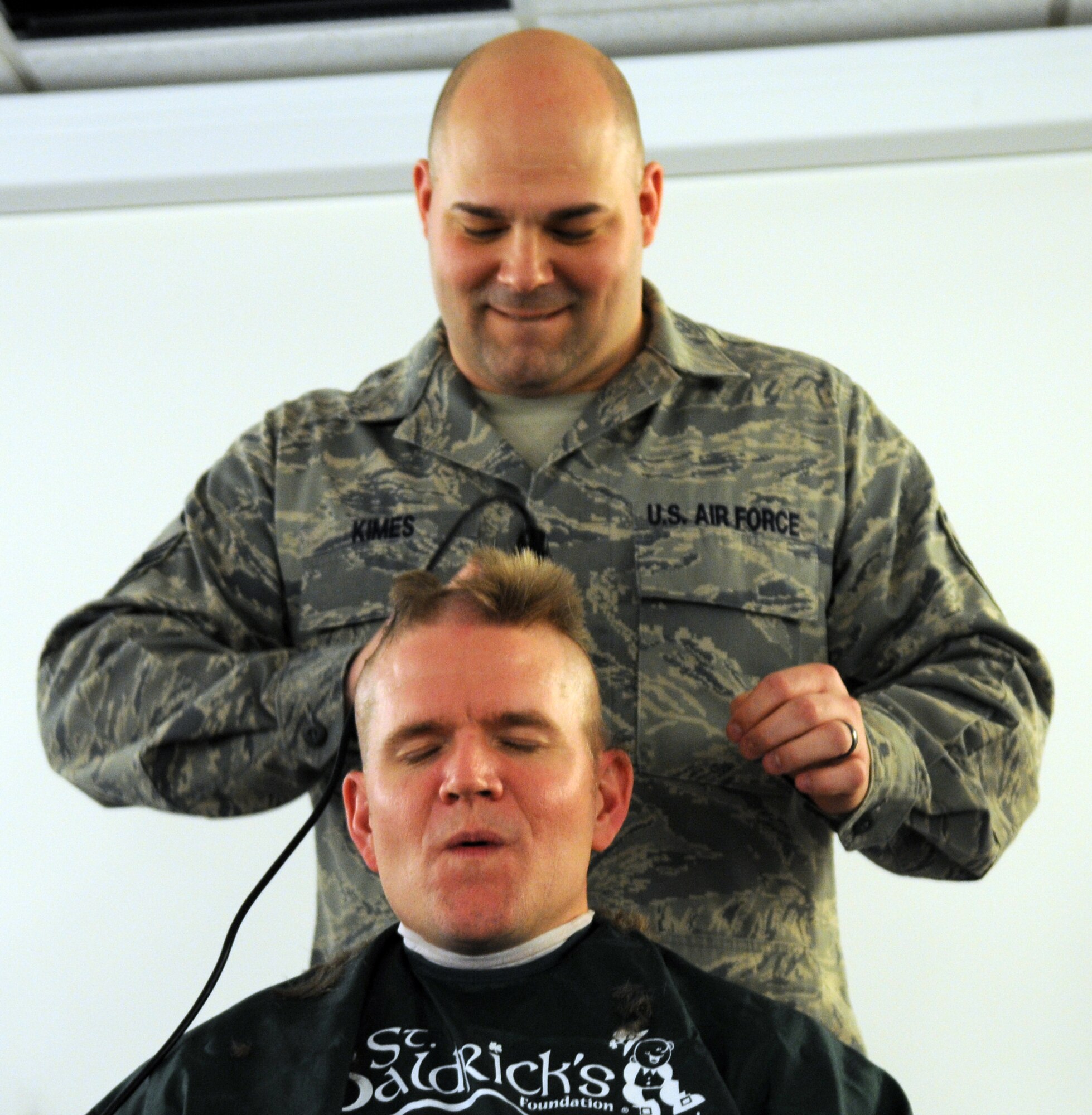RAF MILDENHALL, England -- Master Sgt. Gary Kimes, 351st Air Refueling Squadron first sergeant, shaves a stripe down the center of Lt. Col. Thomas Torkelson’s, 351st ARS commander, head during a St. Baldrick’s Foundation event at the 100th Operations Group auditorium April 7, 2011. According to the St. Baldrick’s Foundation website, the foundation is a volunteer-driven charity committed to funding research to find cures for childhood cancers. Volunteers for the organization raise funds by taking pledges to shave off their hair. Colonel Torkelson held a silent auction for the right to shave his head, raising more than $1,000. Altogether, the Century Tanker Committee raised more than $7,500 for the foundation. (U.S. Air Force photo/Airman 1st Class Rachel Waller)