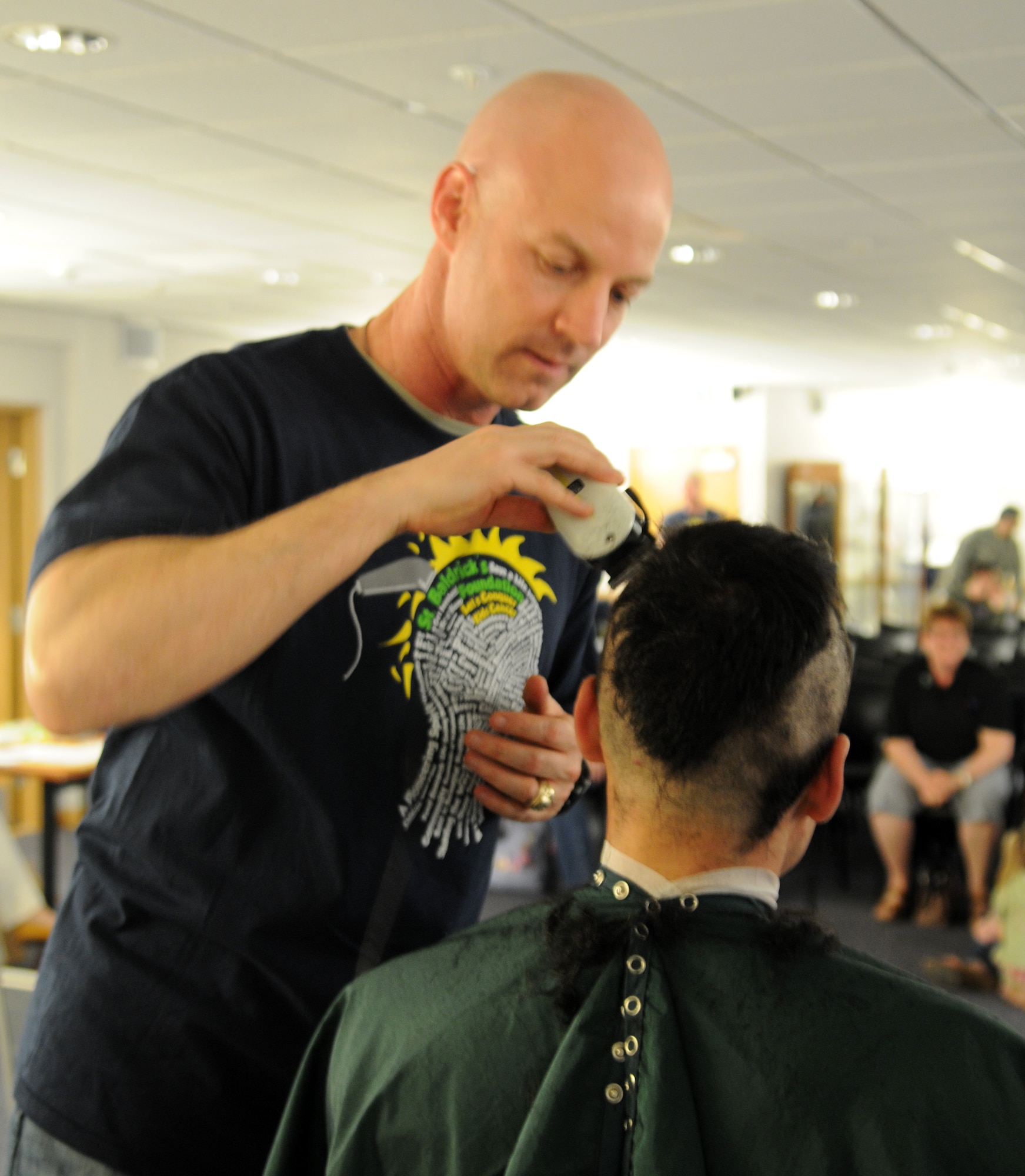 RAF MILDENHALL, England -- Col. Joseph DeMarco, 100th Operations Group commander, shaves off Capt. Nicholas Zervos’, 100th OG, hair during a St. Baldrick’s Foundation event at the 100th Operations Group auditorium April 7, 2011. According to the St. Baldrick’s Foundation website, the foundation is a volunteer-driven charity committed to funding research to find cures for childhood cancers. Volunteers for the organization raise funds by taking pledges to shave off their hair. The Century Tanker Committee and spouses raised more than $7,500 for the foundation. (U.S. Air Force photo/Airman 1st Class Rachel Waller)