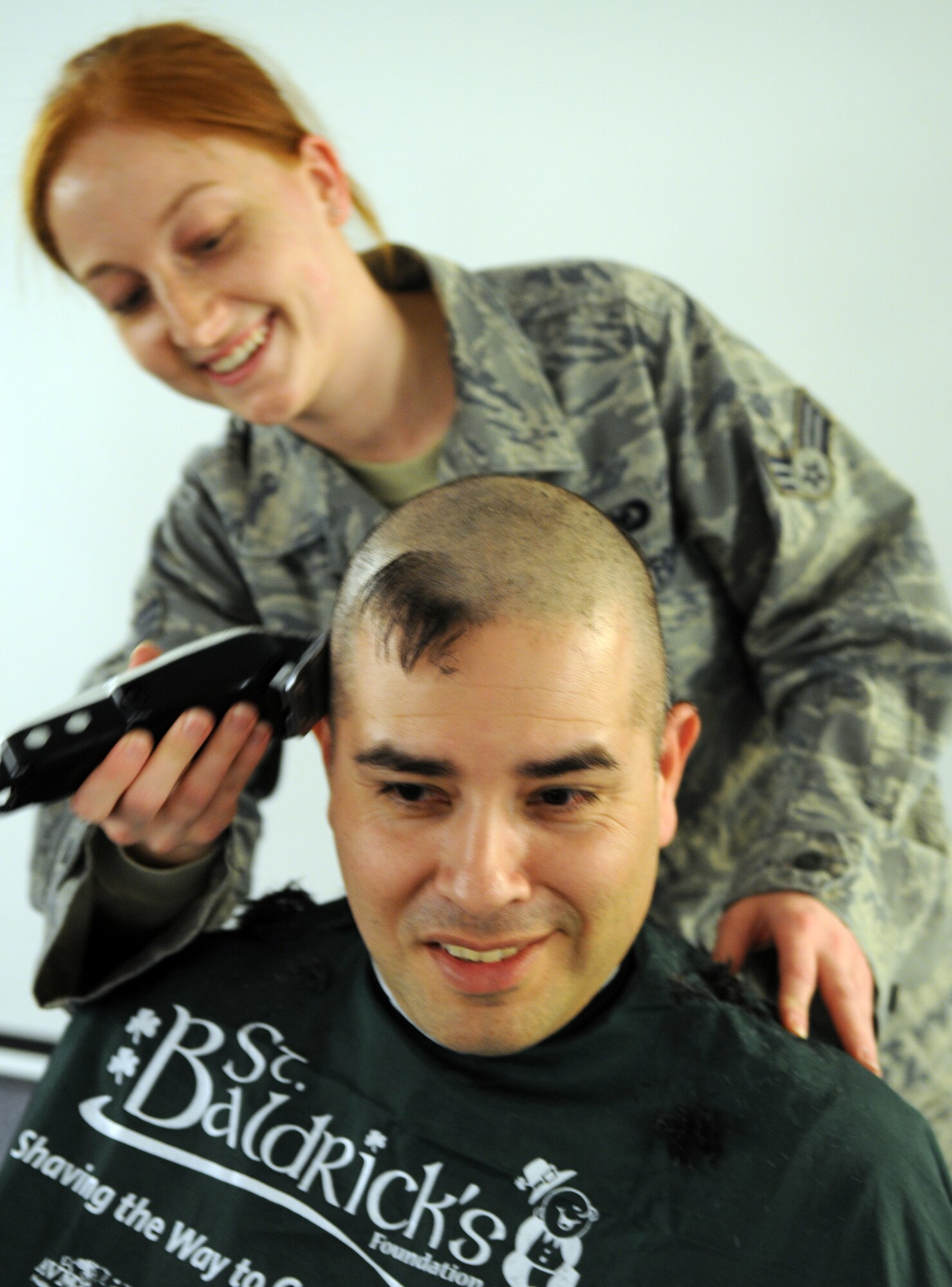 RAF MILDENHALL, England -- Senior Airman Holly Dean, 100th Operations Support Squadron, shaves off Tech. Sgt. Peter Rodriguez’s, 100th OSS, hair during a St. Baldrick’s Foundation event at the 100th Operations Group auditorium April 7, 2011. According to the St. Baldrick’s Foundation website, the foundation is a volunteer-driven charity committed to funding research to find cures for childhood cancers. Volunteers for the organization raise funds by taking pledges to shave off their hair. The Century Tanker Committee raised more than $7,500 for the foundation. (U.S. Air Force photo/Airman 1st Class Rachel Waller)