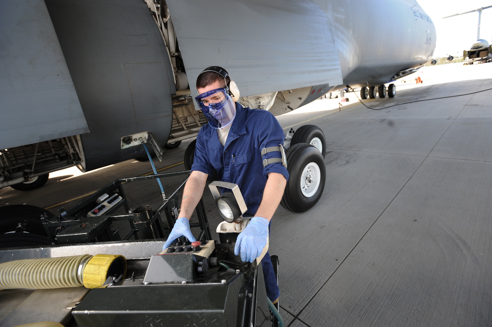 U.S. Air Force Airman 1st Class Jacob Kozlowski, 721st Aerial Port Squadron Fleet Services specialist, pumps fluorine anti-smell solution into a C-5 Galaxy, Ramstein Air Base, Germany, April 11, 2011. Sewage, water and trash are some of the functions Fleet Services performs before every flight. (U.S. Air Force photo by Staff Sgt. Nathan Lipscomb)