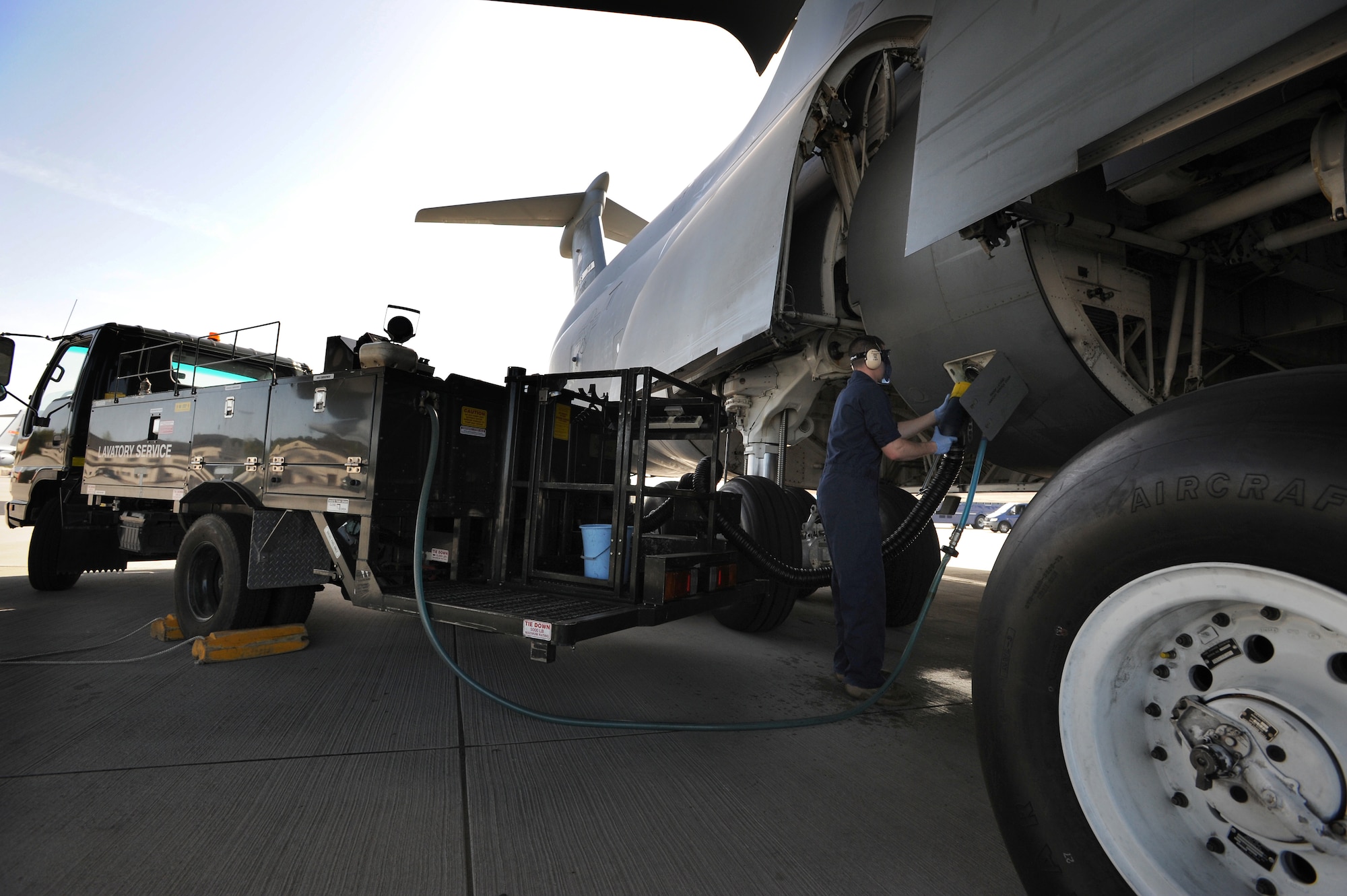 U.S. Air Force Airman 1st Class Jacob Kozlowski, 721st Aerial Port Squadron Fleet Services specialist, pumps fluorine anti-smell solution into a C-5 Galaxy, Ramstein Air Base, Germany, April 11, 2011. Sewage, water and trash are some of the functions Fleet Services performs before every flight. (U.S. Air Force photo by Staff Sgt. Nathan Lipscomb)