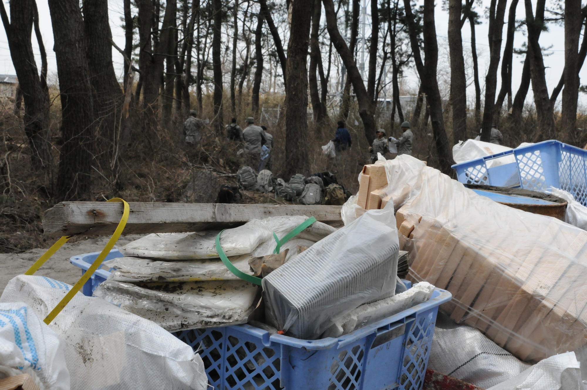 HACHINOHE, Japan --  Debris piles stacked more than two feet high occur as Misawa Air Base Airmen collect debris from a wooded area then bring it to a collection point in Hachinohe. An 8.9 magnitude earthquake March 11 triggered a devastating tsunami that hit Hachinohe, a northeastern Pacific coastal city about 400 miles north of Tokyo. The tsunami devastated commercial and residential buildings in the area. U.S. military forces make daily trips to Aomori prefecture to help restore the area. (U.S. Air Force photo/Staff Sgt. Erica Picariello)