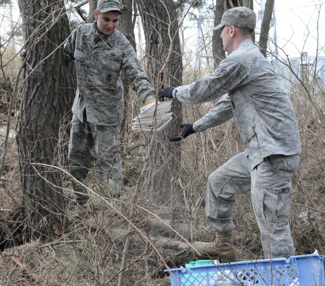 HACHINOHE, Japan --Tech. Sgt. Justin Aguilar, 35th Security Forces Squadron, passes Styrofoam containers to another Misawa Air Base Airman during a humanitarian relief mission to Hachinohe in the Aomori prefecture April 7. A 9.0 magnitude earthquake March 11 triggered a devastating tsunami that hit Hachinohe, a northeastern Pacific coastal city about 400 miles north of Tokyo. (U.S. Air Force photo/Staff Sgt. Erica Picariello)