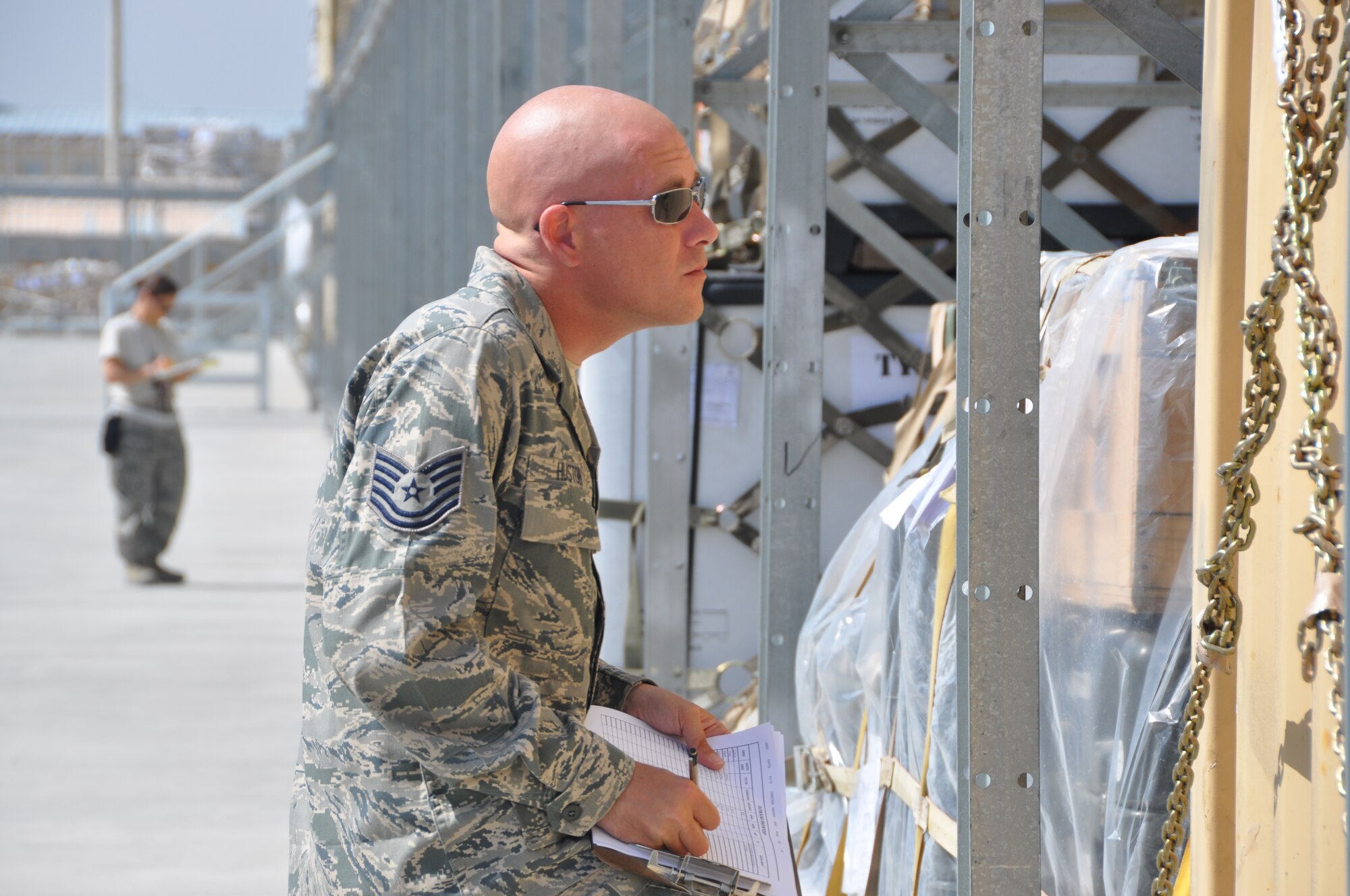 Tech. Sgt. Robert Huston, 60th Aerial Port Squadron aerial porter, carefully checks a row of cargo pallets in the aerial port on Bagram Airfield Apr. 11. Due to the port being the busiest of its kind in all of the Department of Defense, every pallet must be carefully checked prior to shipping to prevent errors or delays in troops getting cargo they need at forward operating bases.