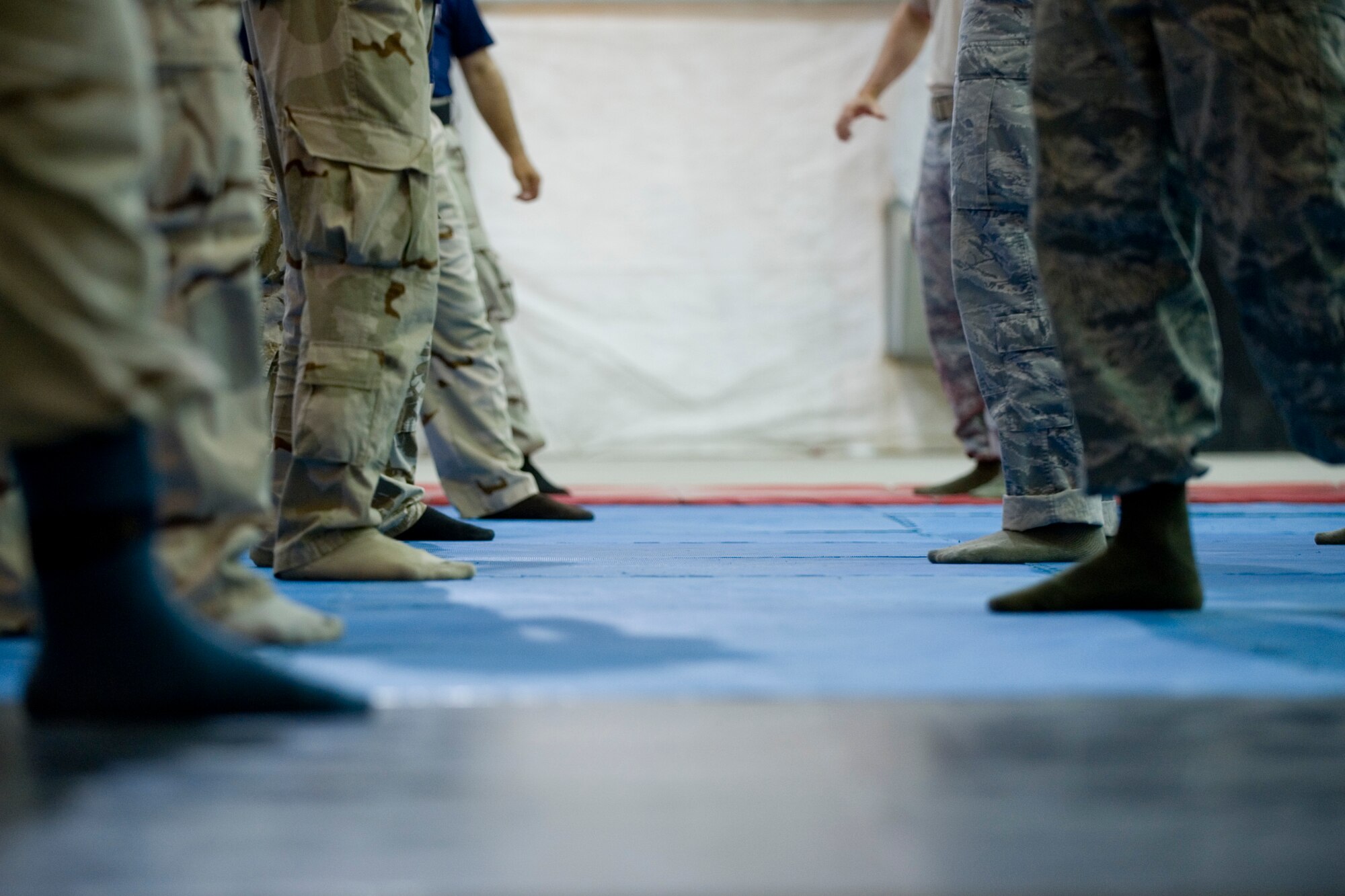 SATHER AIR BASE, Iraq -- U.S Air Force members from the 447th Expeditionary Security Forces Squadron, right, instruct Iraqi airmen on combat tactics used in base security and self defense April 8. Members of the 447th ESFS trained Iraqi security forces airmen ensuring weapons qualification and teaching defensive tactics, vehicle searches and other force protection measures. (U.S. Air Force photo by Staff Sgt. Levi Riendeau)