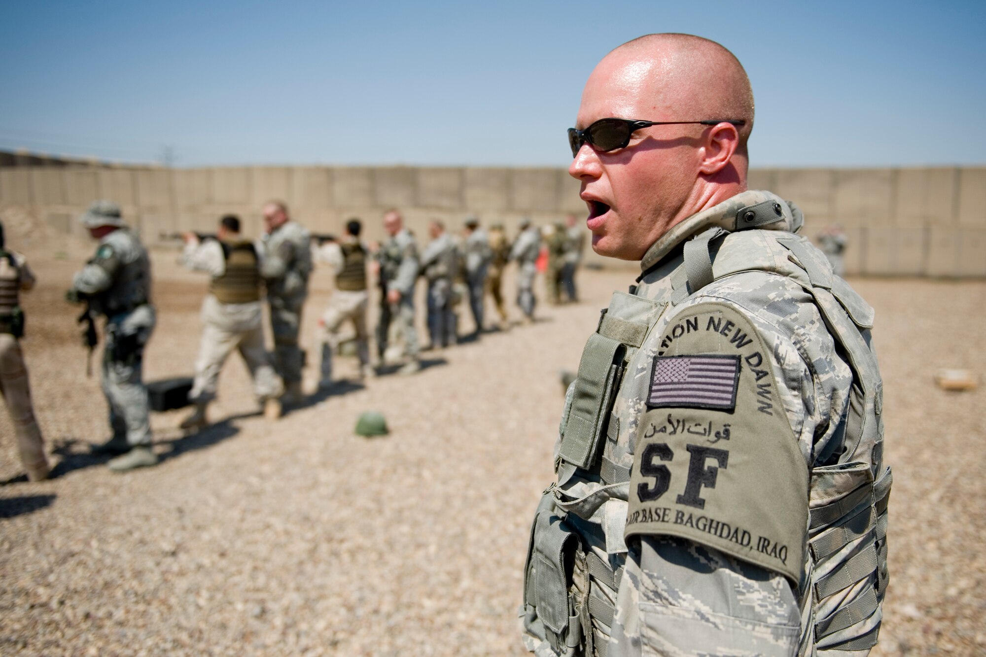 BAGHDAD -- Staff Sgt. Daniel Jung, 447th Expeditionary Security Forces Squadron, calls out commands during a firing drill March 29. Members of the 447th ESFS trained Iraqi security forces airmen ensuring weapons qualification and teaching defensive tactics, vehicle searches and other force protection measures. Sergeant Jung is deployed from the 178th SFS, Ohio Air National Guard, and is a native of Cincinnati. (U.S. Air Force photo by Staff Sgt. Levi Riendeau)