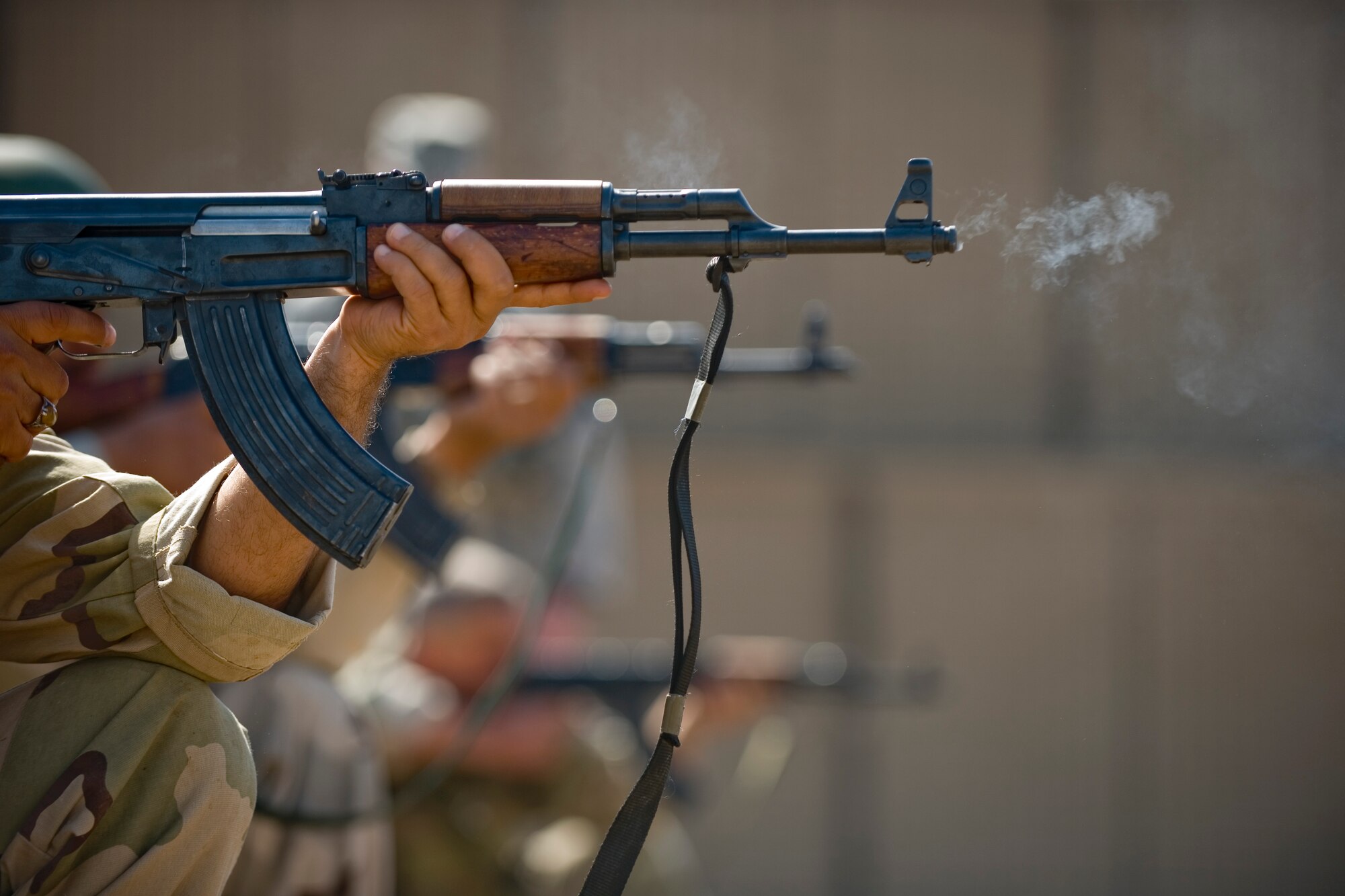 BAGHDAD -- Iraqi airmen fire AK-47s during firing drills March 29. Members of the 447th Expeditionary Security Forces Squadron trained Iraqi security forces airmen ensuring weapons qualification and teaching defensive tactics, vehicle searches and other force protection measures. (U.S. Air Force photo by Staff Sgt. Levi Riendeau)