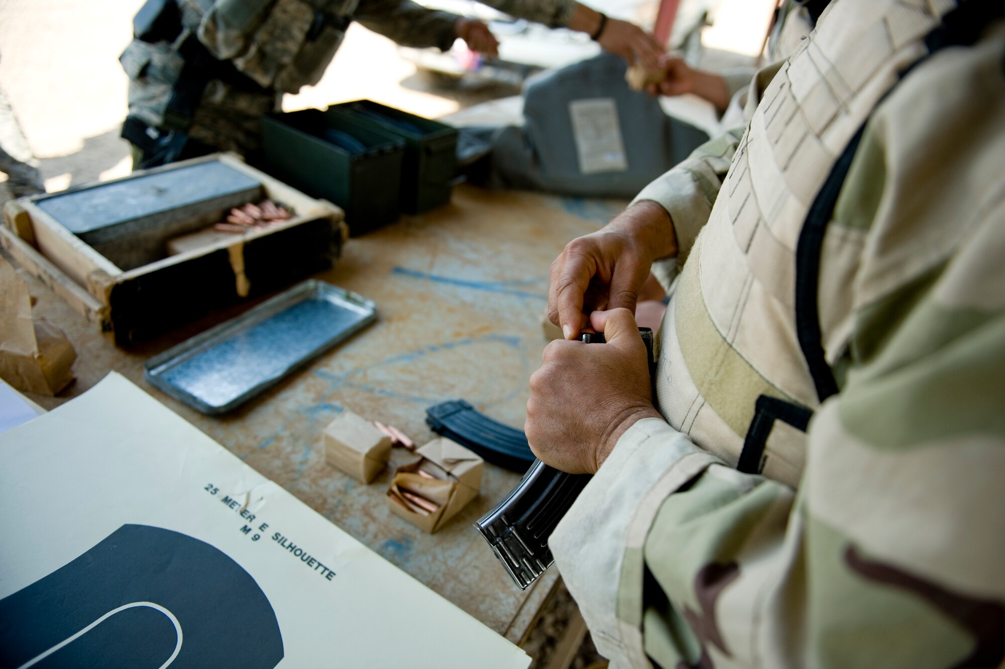 BAGHDAD -- An Iraqi airman loads rounds into an AK-47 magazine March 29. Members of the 447th Expeditionary Security Forces Squadron trained Iraqi security forces airmen ensuring weapons qualification and teaching defensive tactics, vehicle searches and other force protection measures. (U.S. Air Force photo by Staff Sgt. Levi Riendeau)
