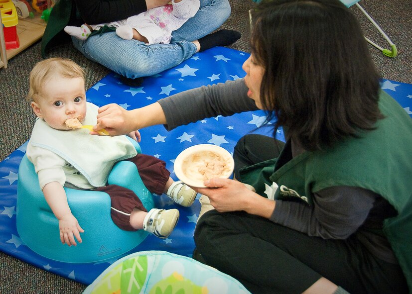 YOKOTA AIR BASE, Japan -- Yukie Kuramochi, a caregiver at the Yume Child Development Center, feeds a child here April 12. Caregivers at the Yume and Kibo CDCs work together to continue normal routines with the children by carrying on everyday activities. (U.S. Air Force photo/Airman 1st Class Lynsie Nichols)