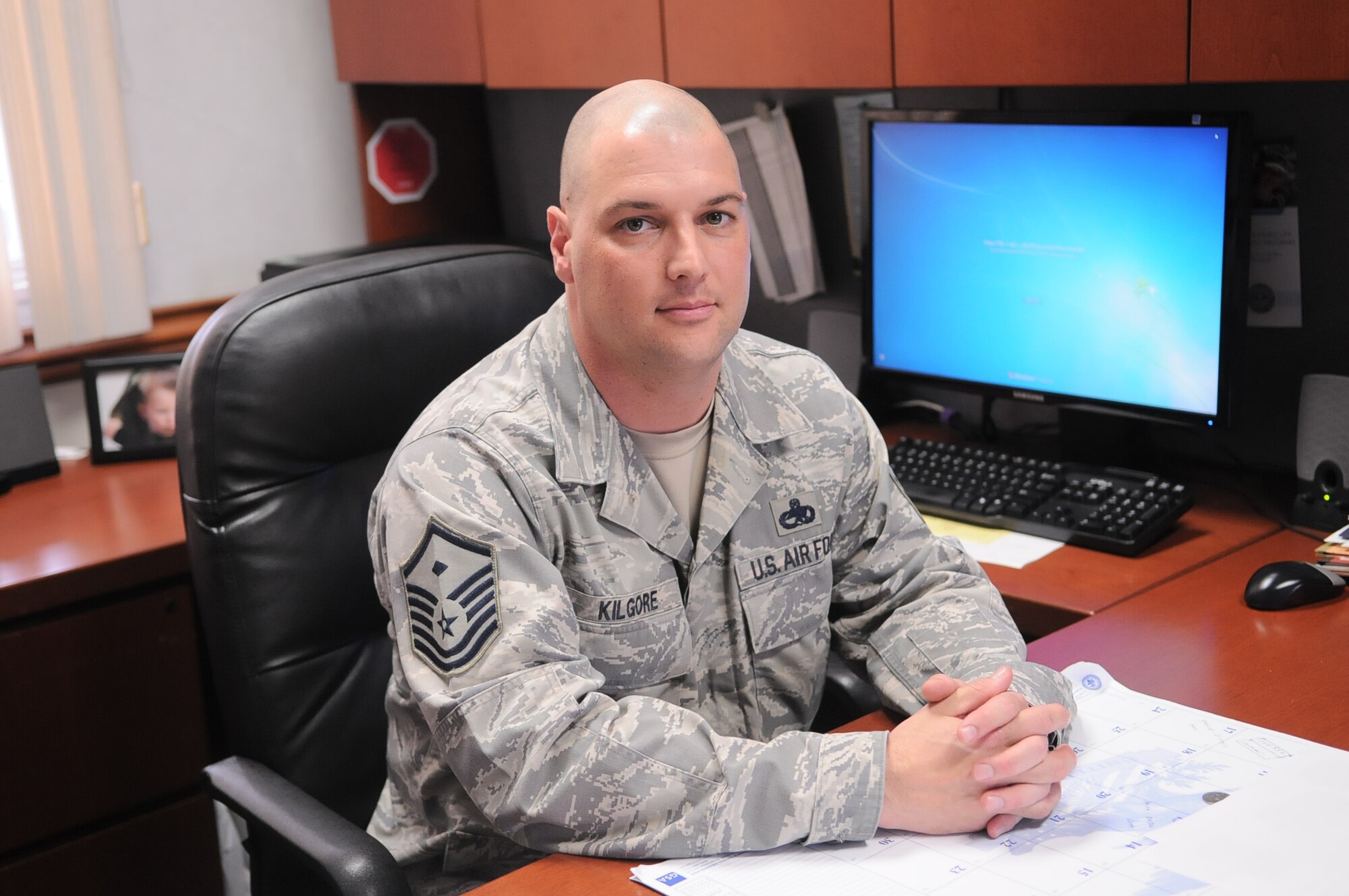 YOKOTA AIR BASE, Japan -- Master Sgt. Michael Kilgore, 374th Civil Engineer Squadron First Sergeant, poses for photo at his desk, at Yokota Air Base, Japan April 8, 2011. "It feels great to help people in need", said Sergeant Kilgore, a native of Zanesville, Ohio. (U.S. Air Force photo/Airman 1st Class Krystal M. Garrett) 