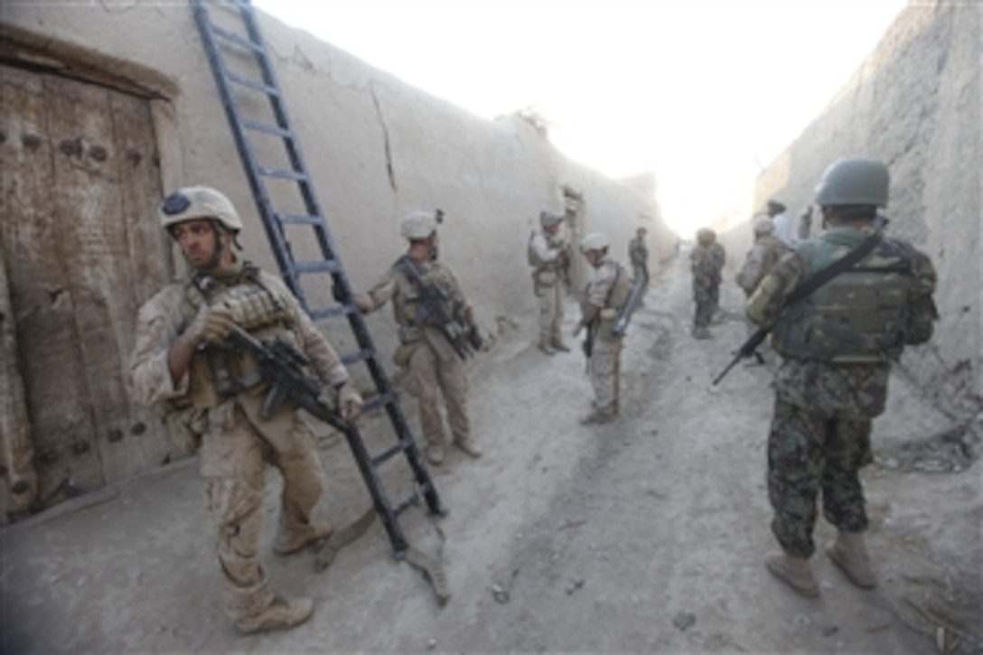 U.S. Marines with 3rd Platoon, Bravo Company, 2nd Reconnaissance Battalion, 2nd Marine Division and Afghan National Army soldiers prepare to clear a compound during a city sweep of Sar Buzeh, Nimroz province, Afghanistan, on March 29, 2011.  The Marines and Afghan soldiers talked with residents of Sar Buzeh about domestic concerns and to gain information about Taliban movement in the area.  