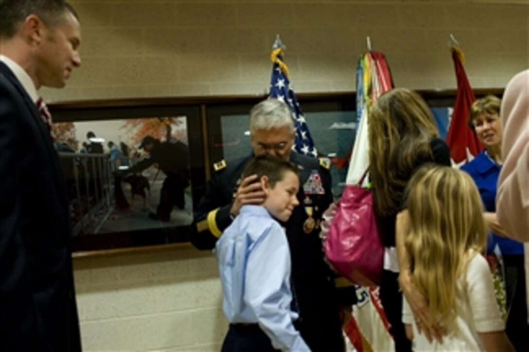 Chief of Staff of the Army Gen. George Casey Jr. embraces his grandson at the conclusion of his retirement ceremony in the Pentagon on Apr. 11, 2011.  
