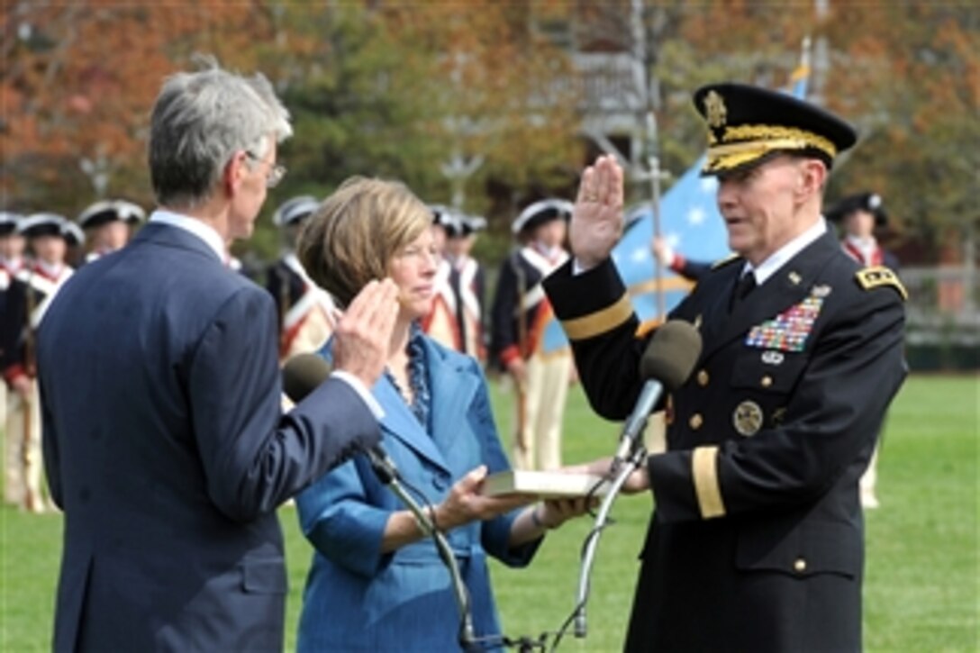 Secretary of the Army John M. McHugh (left) delivers the oath of office to Gen. Martin E. Dempsey (right) while his wife Deanie (2nd from left) looks on during an arrival and swearing-in ceremony at Fort Myer, Va., on April 11, 2011.  Dempsey was sworn in as the 37th Chief of Staff of the Army after Gen. George W. Casey Jr. retired earlier in the day.  