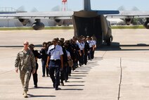 Tech. Sgt. Dallas Criswell, 94th Operations Support Squadron, leads a group of Atlanta area Air Force Junior Reserve Officer Training Corps cadets from a C-130H2 after their familiarization flight, Apr 13.  The 94th Airlift Wing and Dobbins Air Reserve Base hosted more than 1,500 high school JROTC cadets for a look at the Wing and a familiarization flight on a C-130H2 Hercules aircraft.   (U.S. Air Force photo/ Brad Fallin)