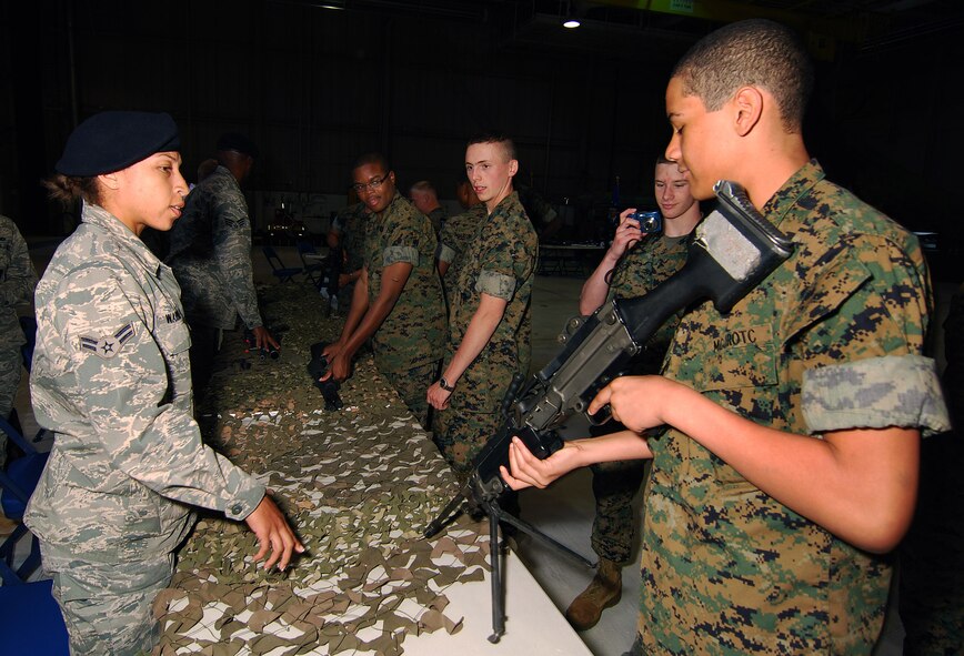 Airman 1st Class Chelle' Warren, 94th Security Forces Squadron, provides information to Marine Corps Junior Reserve Officer Training Corps cadets from the Atlanta regional area about the types of weapons used by Air Force security forces, Apr 13.  The 94th Airlift Wing and Dobbins Air Reserve Base hosted more than 1,500 high school JROTC cadets for a look at the Wing and a familiarization flight on a C-130H2 Hercules aircraft.   (U.S. Air Force photo/ Brad Fallin)