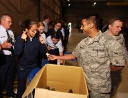 Airman Shehroze Choudhry, 94th Maintenance Squadron, passes out safety items such as goggles, ear plugs, and air sickness bags to Junior Reserve Officer Training Corps cadets from the Atlanta regional area prior to their flight on a C-130H2 Hercules, Apr 12.  The 94th Airlift Wing and Dobbins Air Reserve Base hosted more than 1,500 high school JROTC cadets for a look at the Wing and a familiarization flight on its cargo aircraft.   (U.S. Air Force photo/ Brad Fallin)