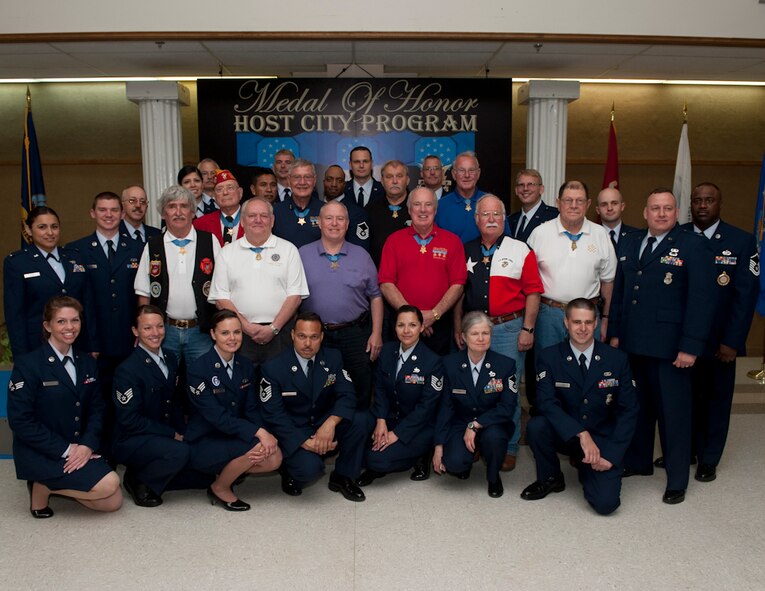 Medal of Honor recipients and members of the 136th Airlift Wing, Texas Air National Guard pose for the group photo during the annual MOH parade held at Gainesville, Texas, the Host City for MOH, April 9, 2011. During the book signing the MOH recipients will be signing their autographs while the 136 AW members assist them. (U.S. Air Force Photo by Tech Sgt. Charles Hatton)