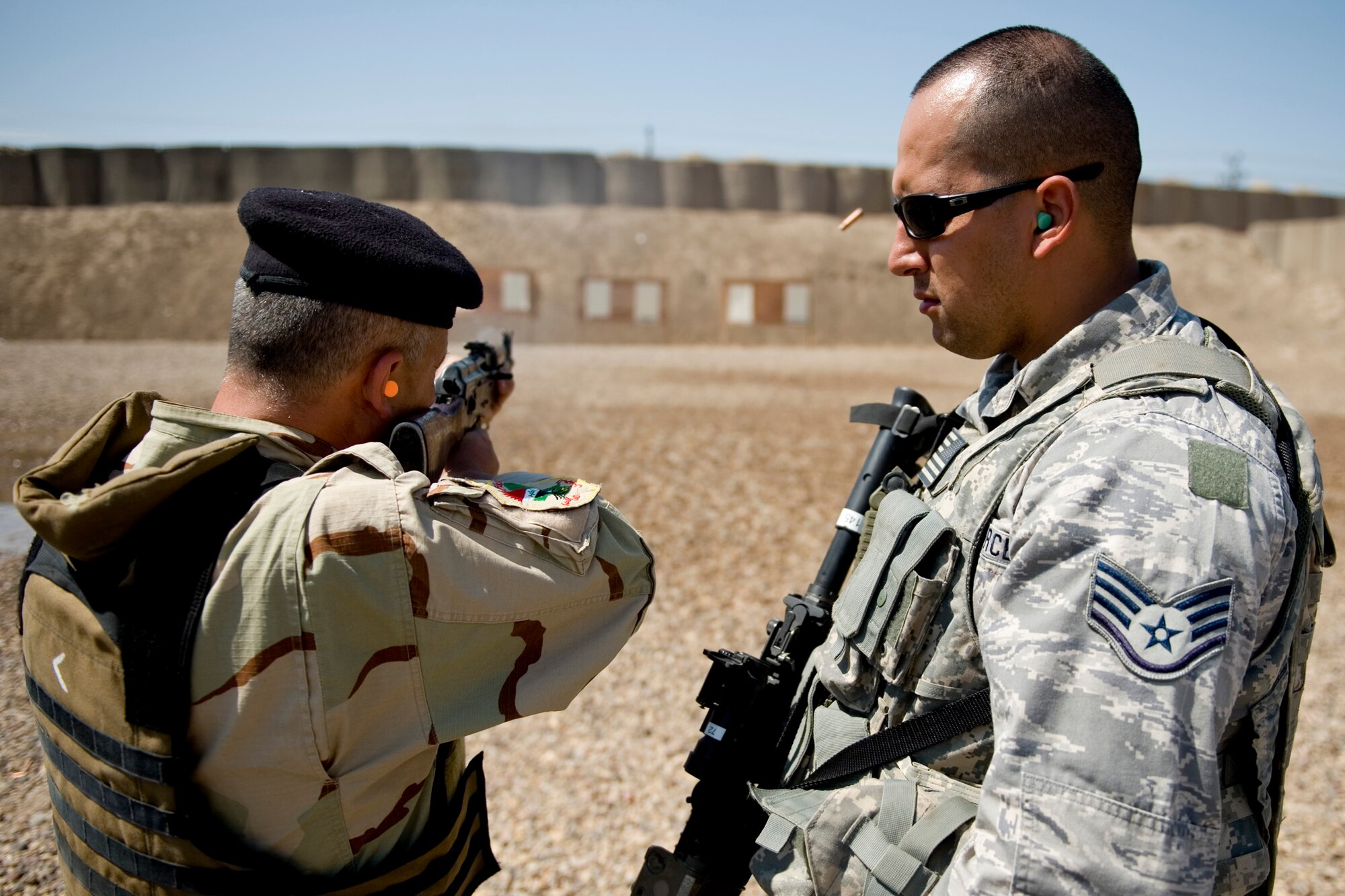 Staff Sgt. George Rincon observes an Iraqi airman during a firing drill March 29, 2011. Members of the 447th Eexpeditionary Security Forces Sqaudron trained Iraqi security forces airmen ensuring weapons qualification and teaching defensive tactics, vehicle searches and other force protection measures. Sergeant Rincon is assigned to the 447th ESFS. (U.S. Air Force photo/Staff Sgt. Levi Riendeau)
