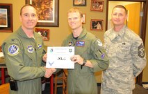 LAUGHLIN AIR FORCE BASE, Texas – Captain Aaron Sick, 87th Flying Training Squadron instructor pilot, poses with Col. Thomas Murphy, 47th Flying Training Wing vice commander, and Chief Master Sgt. Ray DeVite, 47th FTW command chief, after being presented the XLer of the Week award here April 6. The XLer is a weekly award chosen by wing leadership and given to those who consistently make outstanding contributions to Laughlin and their unit. (U.S. Air Force photo by Airman 1st Class Blake Mize)