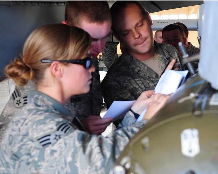 Senior Airman Roxy Shaw, 23rd Civil Engineer Squadron explosive ordnance disposal apprentice, Senior Airman Justin Smith and Staff Sgt. Ryan Prince, 23rd CES EOD journeymen, assess the situation of simulated damage to an A-10C Thunderbolt II during emergency crisis training April 12 at Moody Air Force Base, Ga. Checking the condition and damage of the weapons helped determine the next steps for each situation. (U.S. Air Force photo/Senior Airman Stephanie Mancha)(RELEASED)