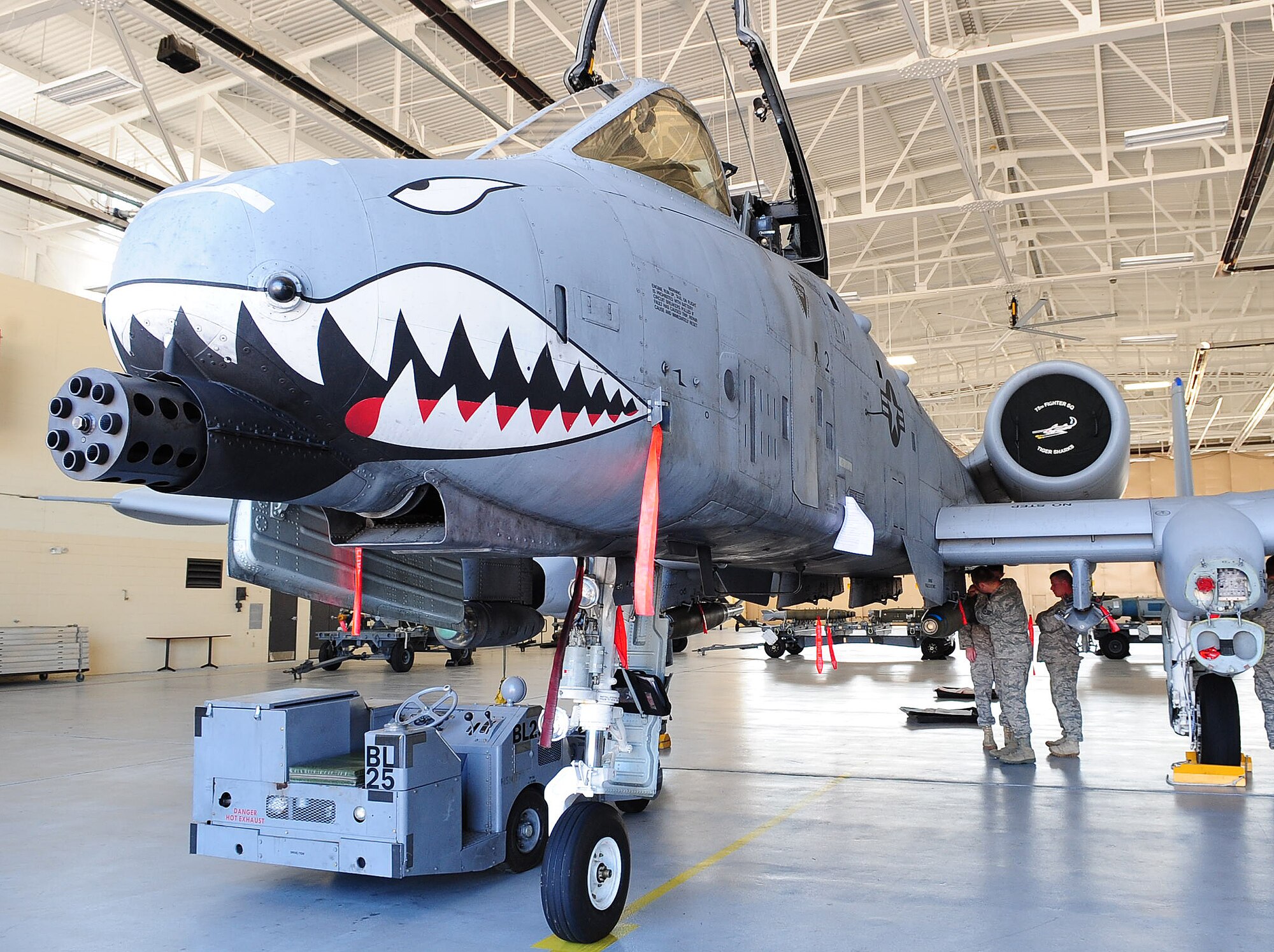 A three-man explosive ordnance disposal team from the 23rd Civil Engineer Squadron assesses the simulated damage on an A-10C Thunderbolt II during training April 12 at Moody Air Force Base, Ga. The team was called in to remove a fuse from a Mark 82 bomb. The training was used to help two Airmen with their upgrade training. (U.S. Air Force photo/Senior Airman Stephanie Mancha)(RELEASED)