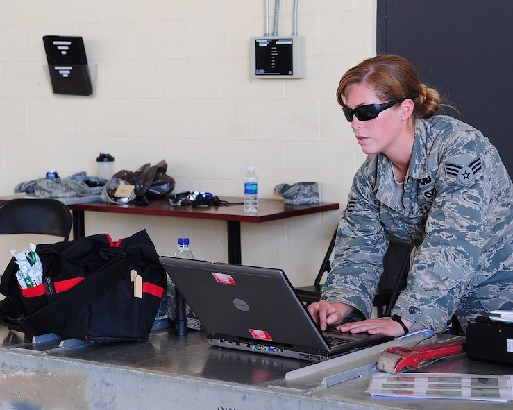 Senior Airman Roxy Shaw, 23rd Civil Engineer Squadron explosive ordnance disposal apprentice, uses the automated explosive ordnance disposal publications system to assist her in identifying munitions during emergency crisis training April 12 at Moody Air Force Base, Ga. AEODPS is a library containing all manufactured products of missiles, bombs and other munitions. (U.S. Air Force photo/Senior Airman Stephanie Mancha)(RELEASED)