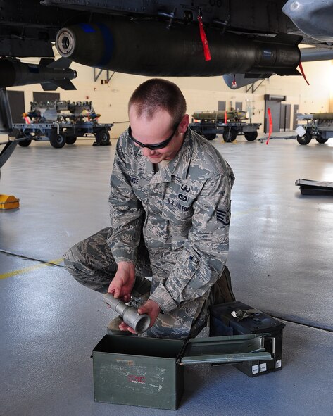 Staff Sgt. Ryan Prince, 23rd Civil Engineer Squadron explosive ordnance disposal journeyman, places a fuse into a metal container during emergency crisis training April 12 at Moody Air Force Base, Ga. Sergeant Prince and the rest of his team safely secured and removed the fuse from a Mark 82 bomb. (U.S. Air Force photo/Senior Airman Stephanie Mancha)(RELEASED)