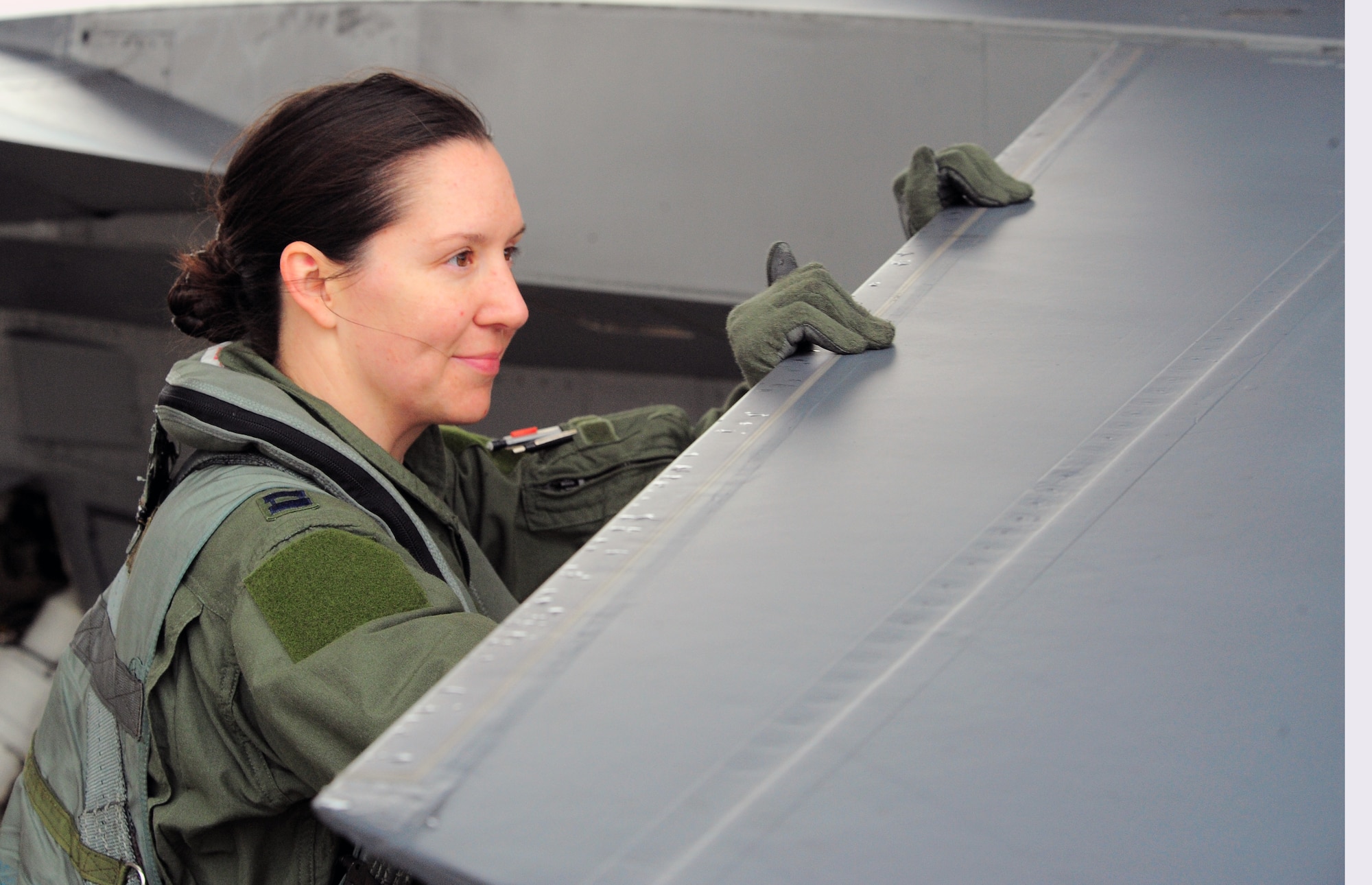 SHAW AIR FORCE BASE, S.C. -- Capt. Betsy Hand, 20th Operations Group standard evaluations liaison officer and 77th Fighter Squadron F-16 pilot, inspects an F-16 March 30, 2011. The Air Force has had women in fighter pilot roles since 1993.
