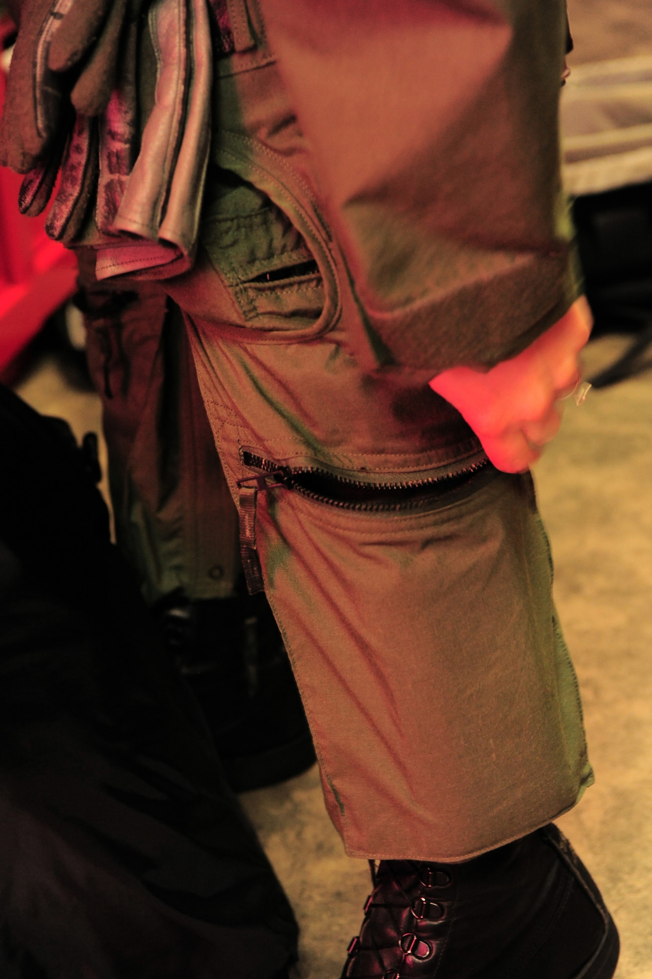 SHAW AIR FORCE BASE, S.C. -- Capt. Betsy Hand, 20th Operations Group standard evaluations liaison officer and 77th Fighter Squadron F-16 pilot, zips a pocket on her flight suit before heading out to the flightline March 30, 2011. The Air Force has had women in fighter pilot roles since 1993.(U.S. Air Force photo/ Airman 1st Class Daniel Phelps)