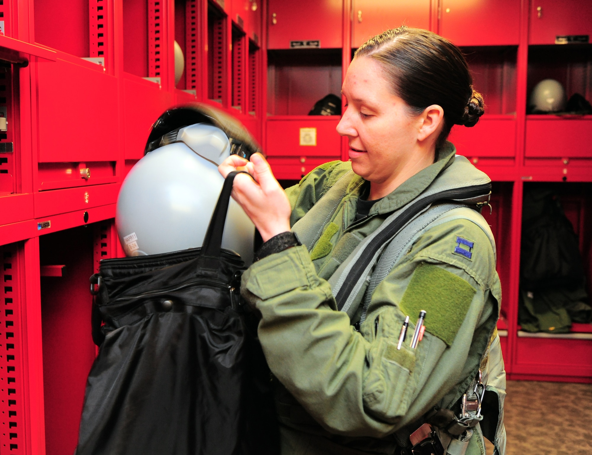 SHAW AIR FORCE BASE, S.C. -- Capt. Betsy Hand, 20th Operations Group standard evaluations liaison officer and 77th Fighter Squadron F-16 pilot, puts her helmet into her flight bag March 30, 2011. The Air Force has had women in fighter pilot roles since 1993.(U.S. Air Force photo/ Airman 1st Class Daniel Phelps)