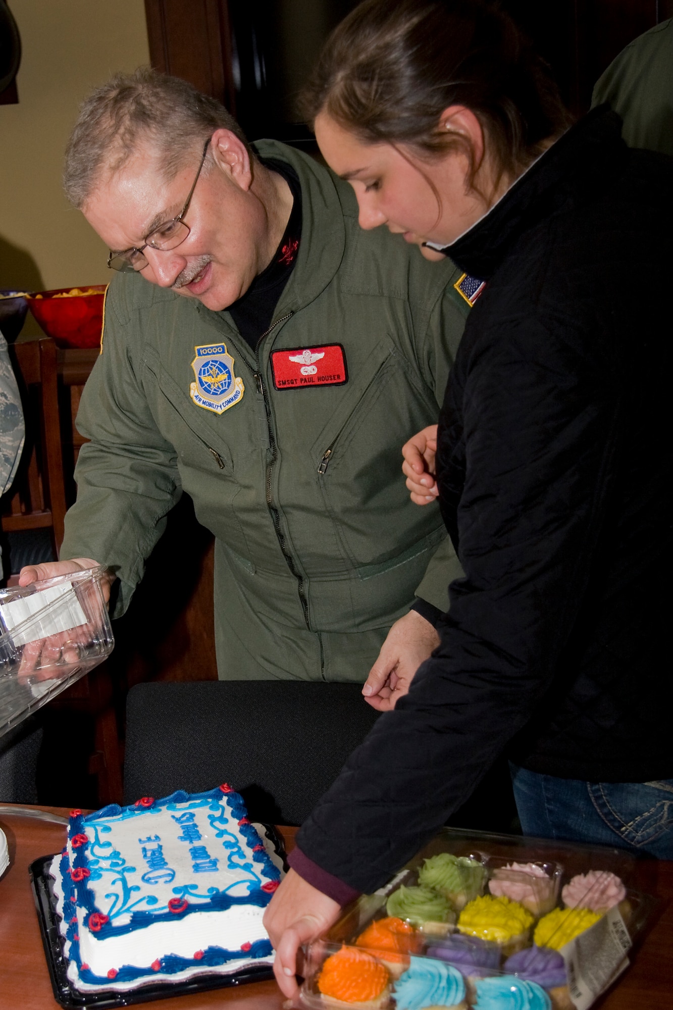 GRISSOM AIR RESERVE BASE, Ind. --  Senior Master Sgt. Paul "Doogie" Houser and his daughter Kelly admire his cake during a reception held in honor of his reaching the 10,000 flight hour mark April 5. Sergeant Houser, 434th Operations Support Squadron in-flight refueling manager, said his accomplishments wouldn't be possible without the support of his wife, Mary, and their three children, Laura, Christopher and Kelly.  (U.S. Air Force photo/Tech. Sgt. Mark R. W. Orders-Woempner)
