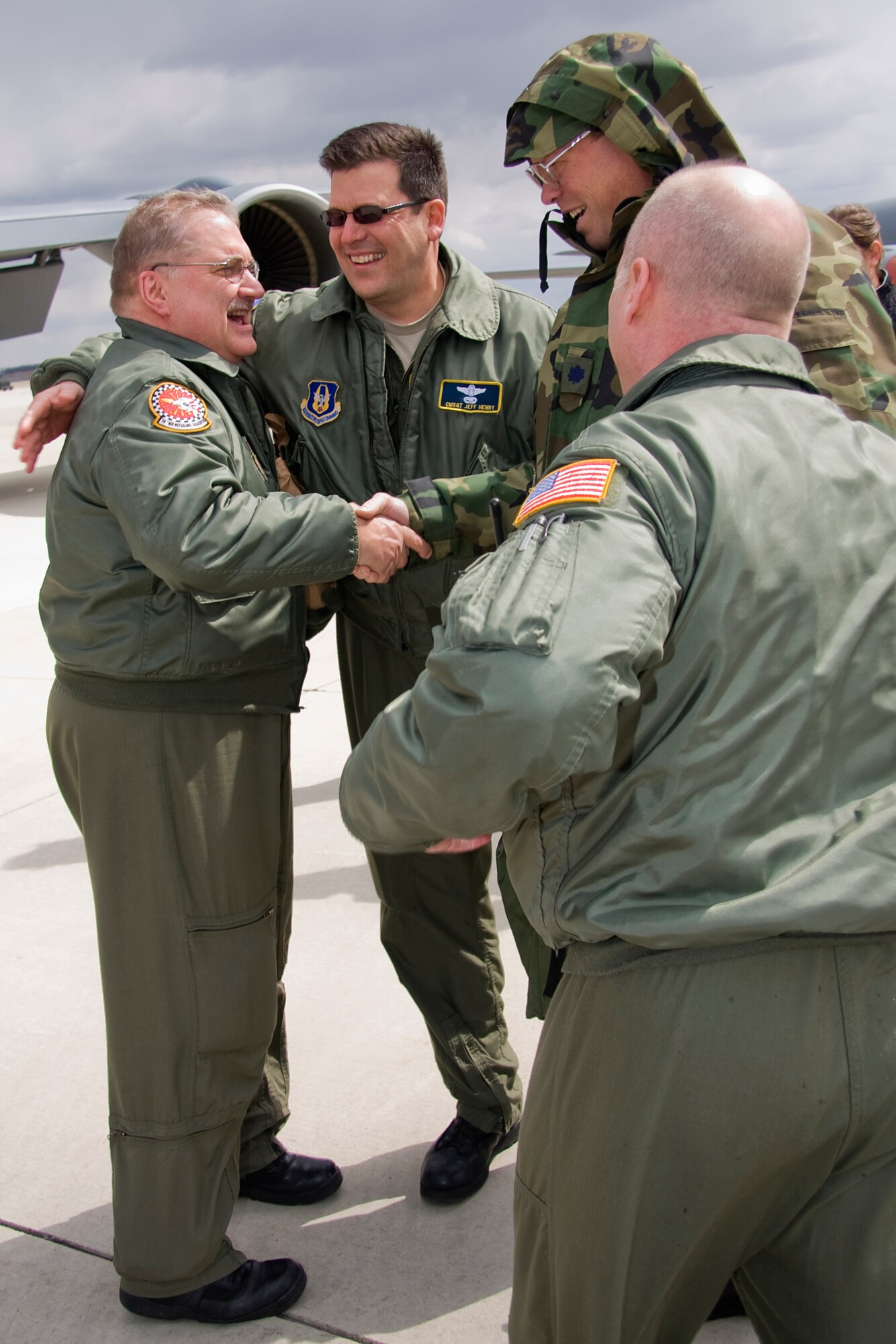 GRISSOM AIR RESERVE BASE, Ind. --  Lt. Col. David Marien shakes the hand of Senior Master Sgt. Paul "Doogie" Houser as Chief Master Sgts. Jeff Henry, center, and Jeff Maier rush in to congratulate Sergeant Houser on achieving 10,000 flight hours April 5.  Sergeant Maier, who began his Air Force career in 1976 as a communications and navigation maintenance specialist, cross trained to be an in-flight refueling technician, better known as a boom operator, in 1980 and joined the Air Force Reserve in 1985. He is now the in-flight refueling manager with the 434th Operations Support Squadron. Colonel Marien is the chief of plans for the 434th OSS. Chief Henry is the 72nd Air Refueling Squadron's in-flight refueling superintendent and Chief Maier is the 74th ARS's in-flight refueling superintendent. (U.S. Air Force photo/Tech. Sgt. Mark R. W. Orders-Woempner)
